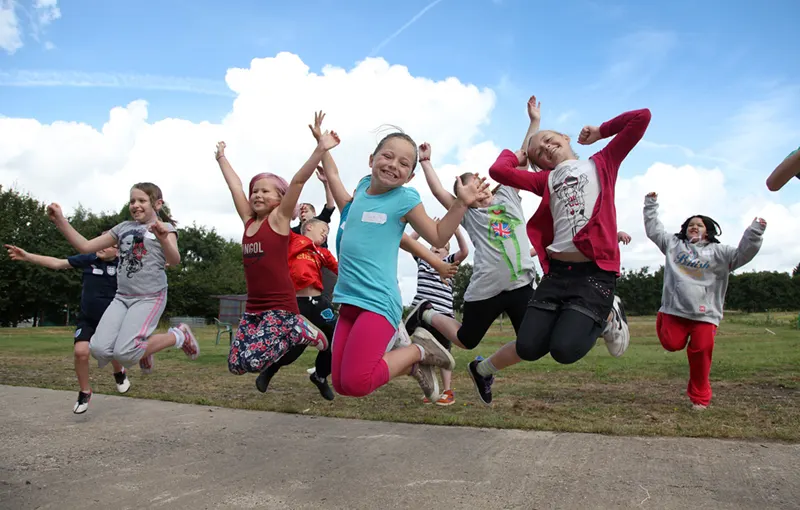 Picture of a group of children mid jump - just some of the people we support