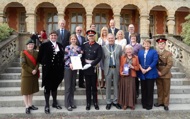 The team receiving the Queen's Voluntary Award from the Lord Lieutenant of Berkshire
